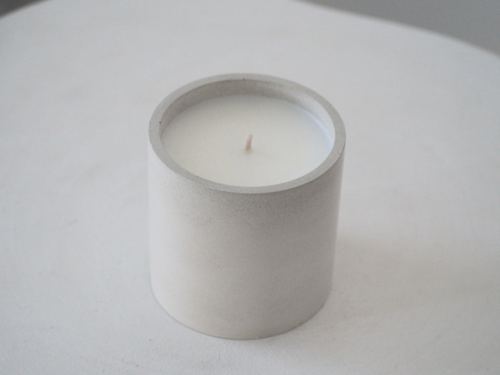 Makana concrete candle on rustic white stool 