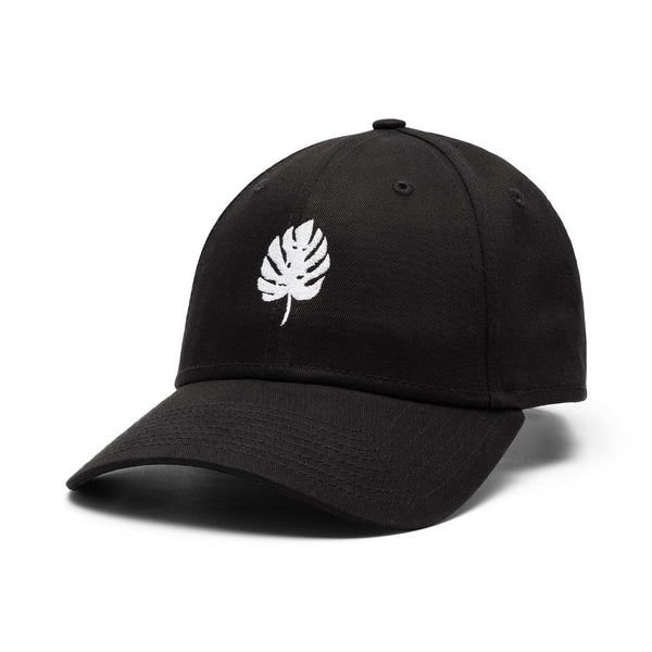 a black cap with a white monstera leaf logo on a white background